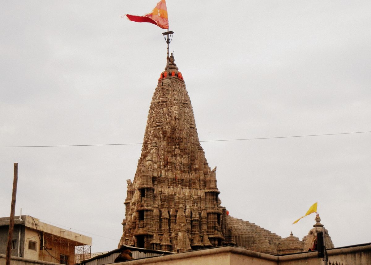Carved spire of the Dwarkadhish Temple in Dwarka with its flag flying
